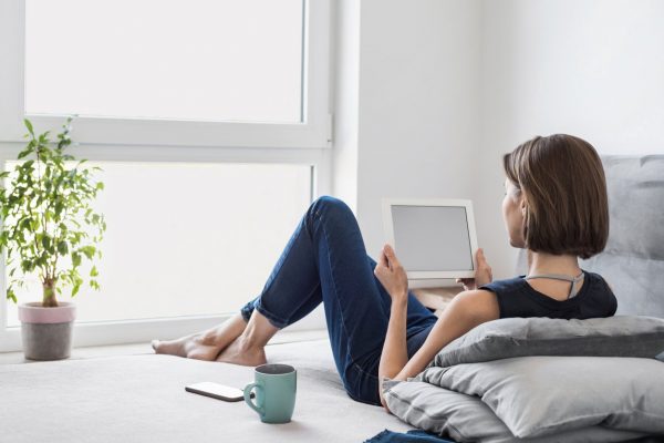Young woman working from home on her iPad, iPad carrying case concept
