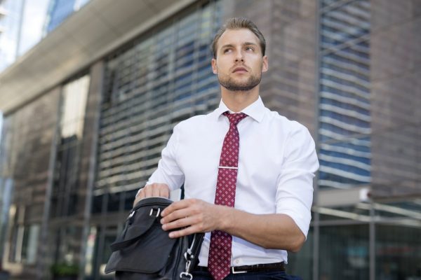 Businessman taking his tablet out of a case, iPad carrying case concept