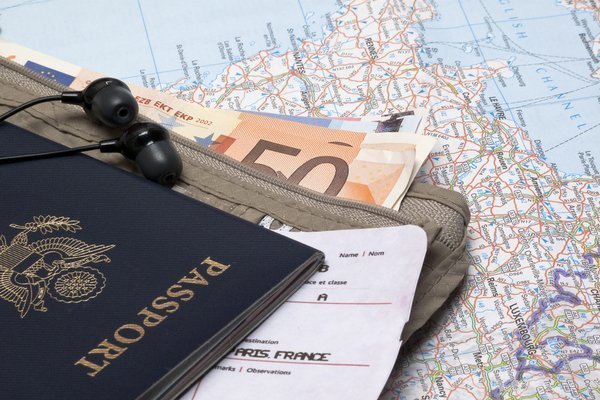 Passport, wallet, and money for traveling, travel neck wallet concept