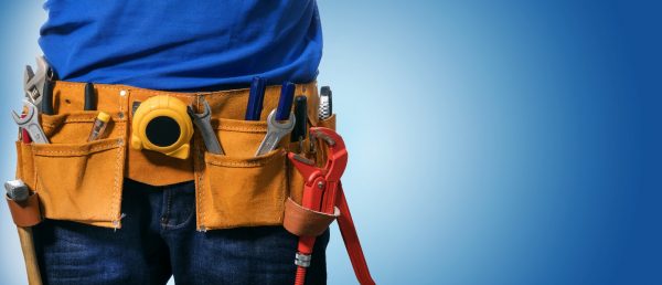 worker-wearing-uniform-with-utility-belt-in-blue-background